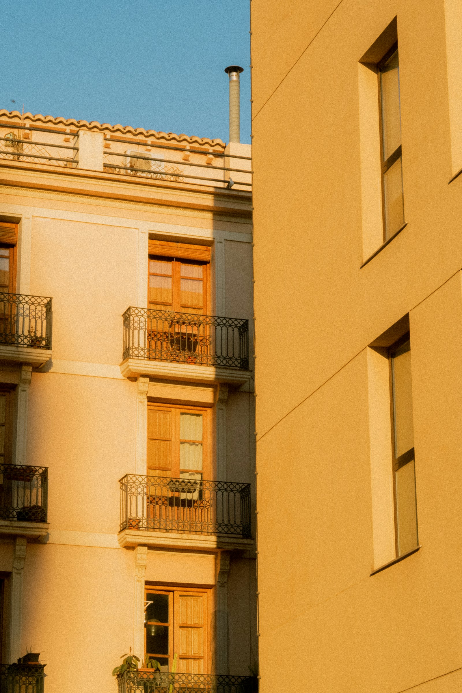 Family arriving at a sunny apartment in Spain with moving boxes